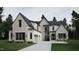 Two-story house with gray roof, white siding, and a three-car garage at 4112 Rockingham Dr, Raleigh, NC 27609