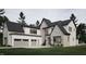 Two-story home exterior with neutral siding and a three car garage at 4112 Rockingham Dr, Raleigh, NC 27609