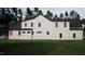 Two story house exterior with white siding and black roof at 4112 Rockingham Dr, Raleigh, NC 27609