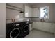Laundry room featuring washer, dryer, and built-in cabinets at 4112 Rockingham Dr, Raleigh, NC 27609