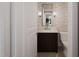 Powder room with dark vanity and elegant mirror at 4112 Rockingham Dr, Raleigh, NC 27609