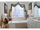 Bathroom with soaking tub, double vanity, and window at 414 Ash Lily Ct, Nashville, NC 27856