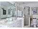 Bathroom with double vanity, shower, and large mirror at 414 Ash Lily Ct, Nashville, NC 27856