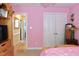 Bedroom with pink walls, double bed, and walk-in closet at 414 Ash Lily Ct, Nashville, NC 27856