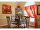 Elegant dining room with glass table and four chairs at 414 Ash Lily Ct, Nashville, NC 27856
