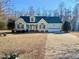 House exterior featuring a two-car garage and manicured lawn at 414 Ash Lily Ct, Nashville, NC 27856