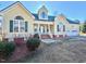 Charming yellow house with green shutters, dormer window, and a well-manicured front yard at 414 Ash Lily Ct, Nashville, NC 27856
