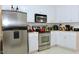 Well-equipped kitchen with stainless steel appliances, white cabinets, and plenty of counter space at 414 Ash Lily Ct, Nashville, NC 27856