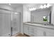 Modern bathroom with double vanity, granite countertop, and a glass-enclosed shower at 433 Rowe Way, Knightdale, NC 27545