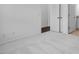 A bright bedroom with white walls and plush carpeting featuring a doorway to another room at 433 Rowe Way, Knightdale, NC 27545
