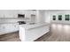 Well-lit kitchen boasts granite countertops, white cabinets, and stainless steel appliances at 433 Rowe Way, Knightdale, NC 27545