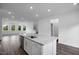 Island kitchen with a stainless steel dishwasher and spacious open floor plan at 433 Rowe Way, Knightdale, NC 27545