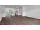 Open-concept living area with luxury vinyl plank flooring and modern kitchen view at 433 Rowe Way, Knightdale, NC 27545