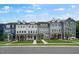 Charming street view of townhomes with well-manicured lawns and inviting entryways at 433 Rowe Way, Knightdale, NC 27545