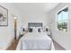 Bright bedroom with a white bed and large window at 4811 Gossamer Ln # 102, Raleigh, NC 27616