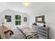 Serene bedroom featuring a dresser, large window, and neutral decor at 4811 Gossamer Ln # 102, Raleigh, NC 27616