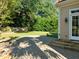 Large brick patio, lush lawn, and mature trees create a relaxing outdoor space at 4913 Great Meadows Ct, Raleigh, NC 27609