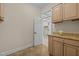 Laundry room with built-in cabinets and tiled floor at 4913 Great Meadows Ct, Raleigh, NC 27609