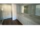 Double vanity bathroom with white cabinets and a large mirror at 5002 Cambrey Dr # 2, Durham, NC 27703