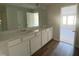 Double vanity bathroom with white cabinets and access to bedroom at 5002 Cambrey Dr # 2, Durham, NC 27703
