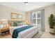 Bright bedroom with light walls and a large window at 506 Misty Willow Way, Rolesville, NC 27571