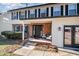 Brick front porch with seating area and black front door at 5315 Oakbrook Dr, Durham, NC 27713