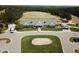 An aerial shot of the clubhouse on a manicured green with an American flag at 64 Barn Owl, Pittsboro, NC 27312