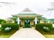 Inviting clubhouse entrance with manicured landscaping, offering a welcoming atmosphere for residents and guests at 64 Barn Owl, Pittsboro, NC 27312