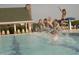 Community pool with children jumping and playing, offering a refreshing and fun gathering spot in the residential community at 64 Barn Owl, Pittsboro, NC 27312
