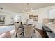 Bright dining area with a round table and four chairs, adjacent to a kitchen and patio at 6422 Swatner Dr, Raleigh, NC 27612