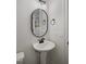 Modern bathroom with pedestal sink and oval mirror at 68 Spring Leaf Ln, Wendell, NC 27591