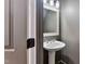 Small bathroom with pedestal sink and framed mirror at 7416 Capulin Crest Dr, Apex, NC 27539