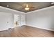 Bedroom featuring hardwood floors, complemented by a large closet, ensuite access, and ceiling fan at 7416 Capulin Crest Dr, Apex, NC 27539