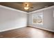 Spacious bedroom with hardwood floors, large windows, and a modern ceiling fan at 7416 Capulin Crest Dr, Apex, NC 27539