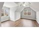 Bright bedroom featuring hardwood floors, two windows, and a ceiling fan at 7416 Capulin Crest Dr, Apex, NC 27539