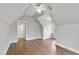 Bedroom with hardwood floors, white walls, and a door to another room at 7416 Capulin Crest Dr, Apex, NC 27539
