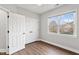 Bright bedroom features hardwood floors, a ceiling fan and a large window with lots of natural light at 7416 Capulin Crest Dr, Apex, NC 27539