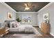 Cozy staged bedroom with area rug, bed with pillows, side tables, and window at 7416 Capulin Crest Dr, Apex, NC 27539