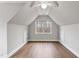 Spacious room with hardwood floors, a ceiling fan, a window, and white walls at 7416 Capulin Crest Dr, Apex, NC 27539