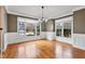 Bright dining room features hardwood floors, wainscoting, and a chandelier at 7416 Capulin Crest Dr, Apex, NC 27539