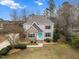 Inviting two-story home with a stone facade, inviting entry, and professionally landscaped front yard at 7416 Capulin Crest Dr, Apex, NC 27539