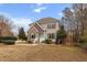 Charming two-story home with a stone facade, inviting entry, and professionally landscaped front yard at 7416 Capulin Crest Dr, Apex, NC 27539