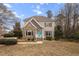 Charming two-story home with a stone facade, inviting entry, and professionally landscaped front yard at 7416 Capulin Crest Dr, Apex, NC 27539