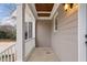 Inviting front porch with white pillars, wood ceiling detail, and neutral paint color at 7416 Capulin Crest Dr, Apex, NC 27539