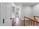 Upstairs hallway with wood floors, white doors, and natural light at 7416 Capulin Crest Dr, Apex, NC 27539