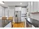 Bright kitchen with stainless steel refrigerator and granite counters at 7416 Capulin Crest Dr, Apex, NC 27539