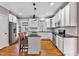 Updated kitchen features white cabinets, a large island, and stainless appliances at 7416 Capulin Crest Dr, Apex, NC 27539