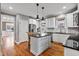 Spacious kitchen with white cabinets and a center island with barstool seating at 7416 Capulin Crest Dr, Apex, NC 27539
