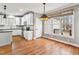 Charming kitchen with white cabinets, stainless appliances, subway tile backsplash and wood flooring at 7416 Capulin Crest Dr, Apex, NC 27539