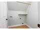 Well-lit laundry room featuring tile flooring, hookups, shelf, and white walls at 7416 Capulin Crest Dr, Apex, NC 27539